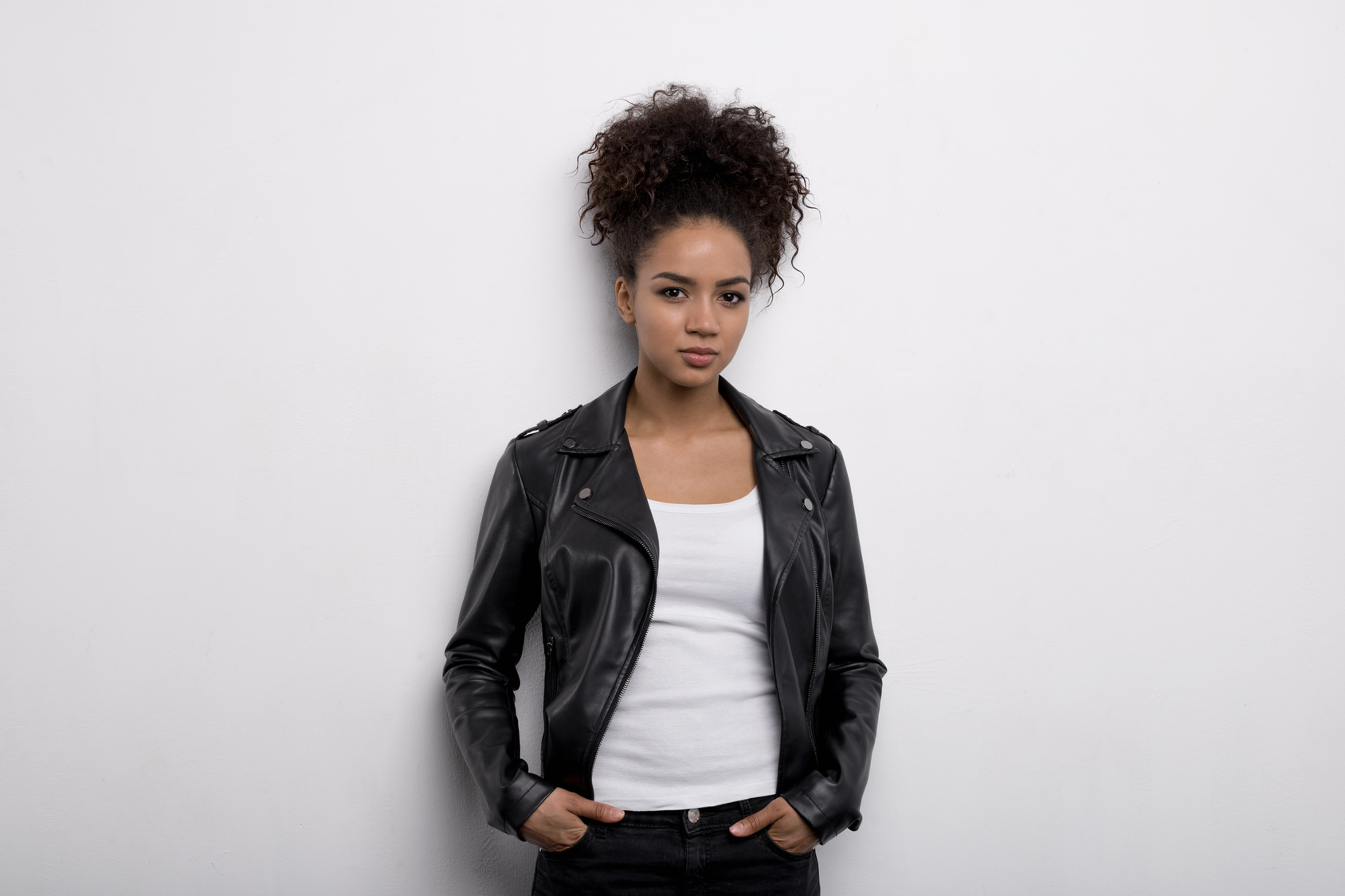 Woman wearing leather jacket, hands in pocket